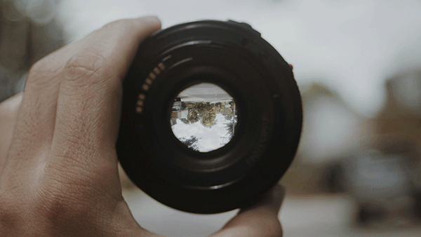 'Close-up of a Man Holding a Camera Lens' by Nothing Ahead on Pexels