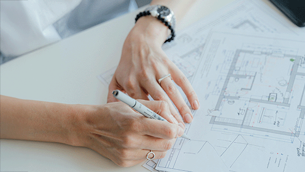 'Architect writing on Floor Plans' by Antoni Shkraba Studio on Pexels; Cropped and mildly expanded using Firefly A.I. in Photoshop.